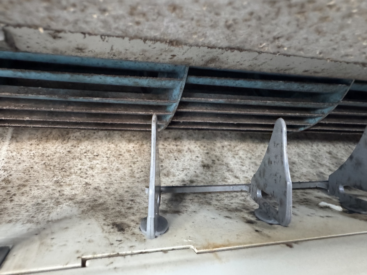 Close view of grime on an internal heat pump fan and housing